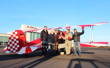 Gruppenbild mit Damen: Die Spiegel-TV-Redakteurinnen Kirstin Hoehne und Annika Seemann (im Fliegerkombi als Thea Rasche) hatten auf der Lipper Höhe bei den Sterntaktlern Friedrich Diehl (Dritter von links) und Thomas Holz (rechts) Station gemacht, um ein bisschen von der Atmosphäre einzufangen, wie sie den Piloten in den 20-er und 30-er Jahren des vorigen Jahrhunderts begegnet ist. (Foto: Alex Klank/biplanes.de)